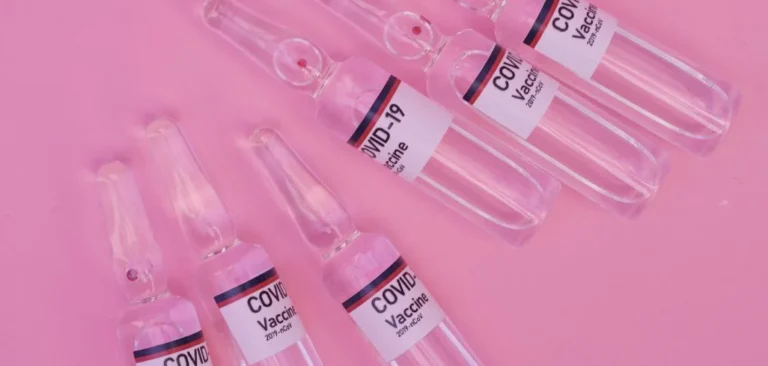 Empty medical syringes on a pink background