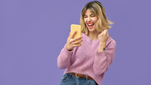 Blond woman laughing loking at her phone